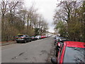 ST1494 : Car-lined and tree-lined part of Station Road, Ystrad Mynach by Jaggery