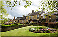 NZ0737 : Flower bed and lawn at Angate Square by Trevor Littlewood