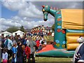 SJ9593 : Bouncy Castle and swings by Gerald England