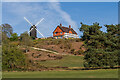 TQ2350 : Reigate Heath Windmill and Reigate Heath Golf Club clubhouse  by Ian Capper