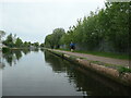 SP0587 : Jogger heading north on the BCN main line by Christine Johnstone