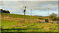 NS8873 : Disused railway line crosses minor road by Balmitchell farm by AlastairG