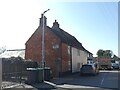 TL2249 : House with old enamel advertising sign, King Street, Potton by David Smith