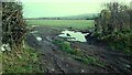 NY2247 : Muddy gateway to field on east side of road opposite Waverton Old School by Roger Templeman