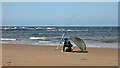 NT7574 : A sea angler at Thorntonloch by Walter Baxter