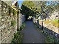 NY3239 : Path beside St. Kentigerns Church by Adrian Taylor