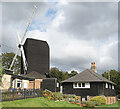 TQ2350 : Windmill and Wooden Cabin by Des Blenkinsopp