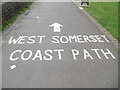 SS9746 : West Somerset Coast Path wording on the seafront pavement by David Hillas