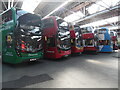 TQ4266 : Six buses in a row in Bromley Bus Garage (2) by David Hillas