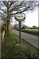 TG2120 : Stratton Strawless Village sign by Geographer