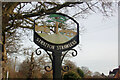 TG2120 : Stratton Strawless Village sign by Geographer