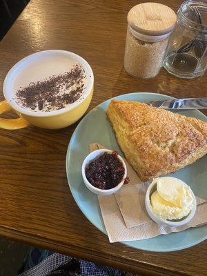 Photo of Lovecrumbs - Edinburgh, EDH, GB. Scone with jam and cream. Salted caramel hot chocolate!!