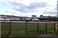 SO9524 : Stile to the footpath at Cheltenham Racecourse by Steve Daniels