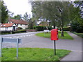 TM1359 : A1120 junction with Quoits Meadow & Quoits Meadow Postbox by Geographer