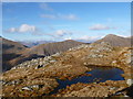 NN1440 : Small pool north-west of Beinn nan Aighenan summit by Alan O'Dowd