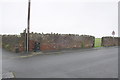 NY0337 : Wall of the Roman Fort at Camp Road/footpath junction by Roger Templeman