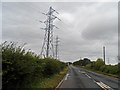 TG4902 : Power lines cross the A143 near Belton by Bikeboy