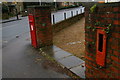 TQ2470 : Post box and defunct stamp machine, bottom of Spencer Hill by Christopher Hilton