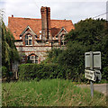 SU3059 : Brick and flint cottage by James Harrison