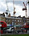 TQ3276 : White, yellow and red tower cranes, Camberwell by Robin Stott