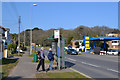 SX9777 : Walkers looking up bus times, Exeter Road, Dawlish by Robin Stott