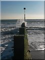 SZ0890 : Bournemouth: a groyne is gently sprayed by Chris Downer