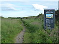 NU2422 : English Heritage Sign at Dunston Steads by PAUL FARMER