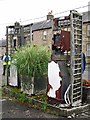 NY4887 : Old petrol pumps outside closed-down garage by Rose and Trev Clough