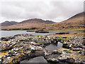 NM4936 : Rocks and rock pool at shore of Loch na Keal by Trevor Littlewood