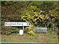 TM4198 : Roadsign & Low Road sign on Loddon Road by Geographer