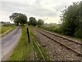 TM4063 : Railway line and lane, by Kelsale Covert by Christopher Hilton