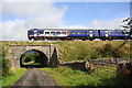 NY7507 : Passenger train heads for Carlisle over Bridge SAC/186 by Roger Templeman