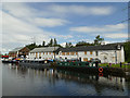 NS5867 : Buildings and boats at Old Basin by Stephen Craven