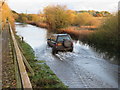 TL4279 : Driving through the flood water at Sutton Gault - The Ouse Washes by Richard Humphrey