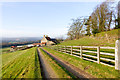 NZ1431 : Wooden fence alongside access road by Trevor Littlewood