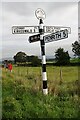 NY5437 : Signpost, letter box, noticeboard and fields at crossroads in North Dykes by Roger Templeman