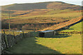 NT9715 : Shed and pen near Hartside by Derek Harper