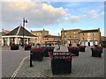 TL2797 : Poppies on planters in Whittlesey Market Place by Richard Humphrey