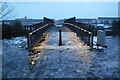 SK5806 : Lit-up footbridge on a cold evening by Pierre Marshall