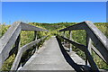 NX0941 : Footbridge from Port Logan Bay by Billy McCrorie