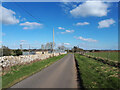 SP1014 : Minor road to Northleach, passing electricity distribution site by Vieve Forward