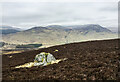 NN9961 : Heather slope with protruding boulder by Trevor Littlewood