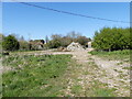 TG3027 : Entrance to farmyard and cattle shed by David Pashley