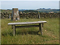 NT4328 : Summit seat and trig point, Harehead Hill by Jim Barton