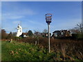 TQ7416 : Beacon and windmill at Kings Mead by Marathon