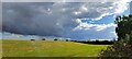 TM4159 : Dark clouds over the reservoir embankment, Knodishall Whin by Christopher Hilton