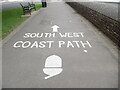 SS9746 : South West Coast Path wording on the seafront pavement by David Hillas