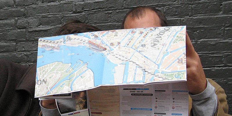 Two men are confused by a paper map