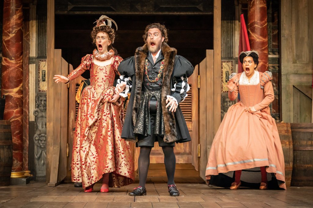 Three actors in Elizabethan garb scream in an exaggerated fashion.