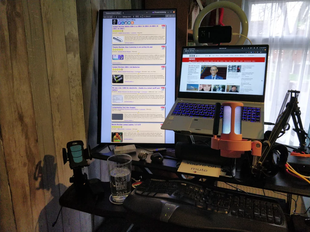 A large vertical monitor atop a standing desk.